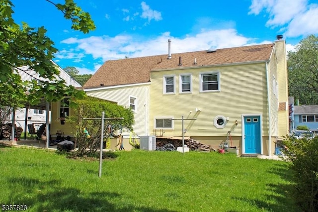 95 Richard St, Rockaway Twp, NJ 07801 - rear view of property featuring central AC unit, a chimney, and a lawn