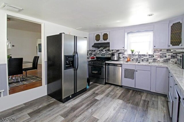 95 Richard St, Rockaway Twp, NJ 07801 - kitchen with stainless steel appliances, a sink, wood finished floors, and tasteful backsplash