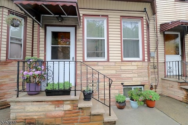 view of exterior entry with stone siding