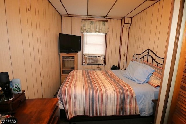 bedroom with cooling unit and wood walls