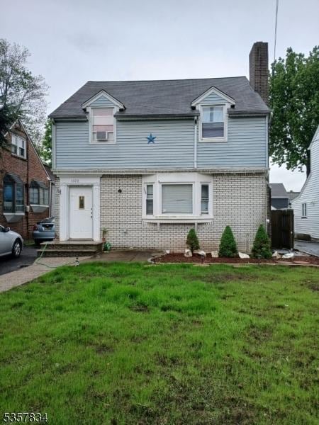 1020 Harding Rd, Elizabeth City, NJ 07208 - view of front of house featuring a chimney, brick siding, and a front lawn