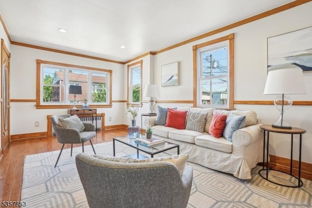 living room featuring wood-type flooring, healthy amount of natural light, ornamental molding, baseboards, and recessed lighting