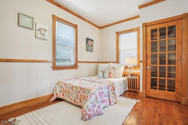 bedroom featuring ornamental molding and hardwood / wood-style floors