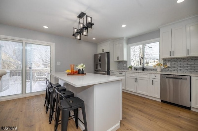 7 Winslow Ave, East Brunswick Twp, NJ 08816 - kitchen with appliances with stainless steel finishes, a sink, backsplash, white cabinetry, and recessed lighting