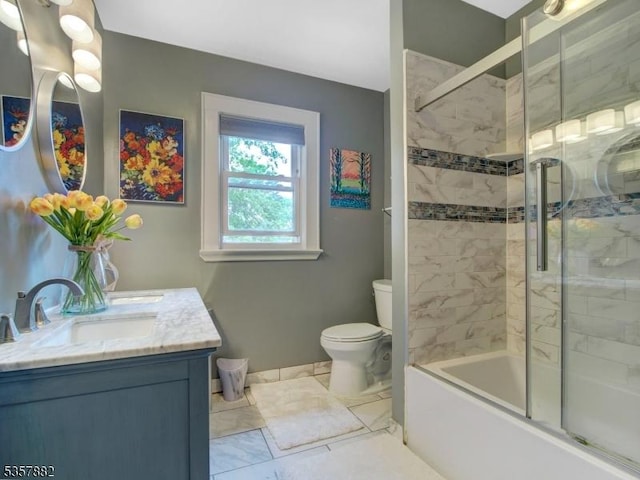full bathroom with vanity, toilet, combined bath / shower with glass door, and baseboards