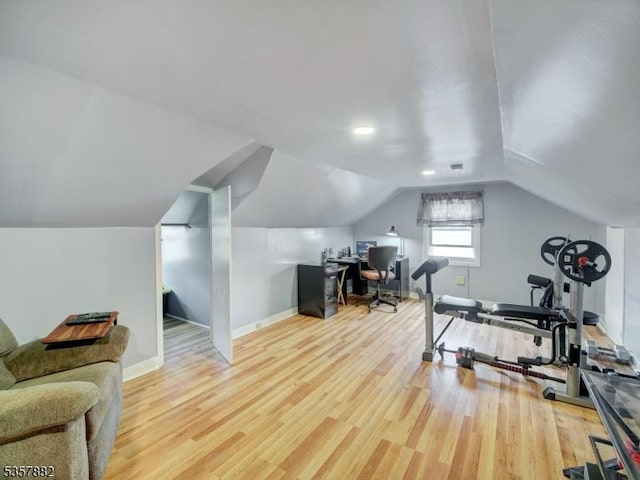 office area featuring wood finished floors, baseboards, and lofted ceiling