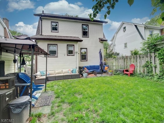 rear view of house with outdoor lounge area and a gazebo