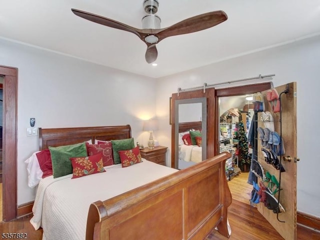 bedroom with wood finished floors and a ceiling fan