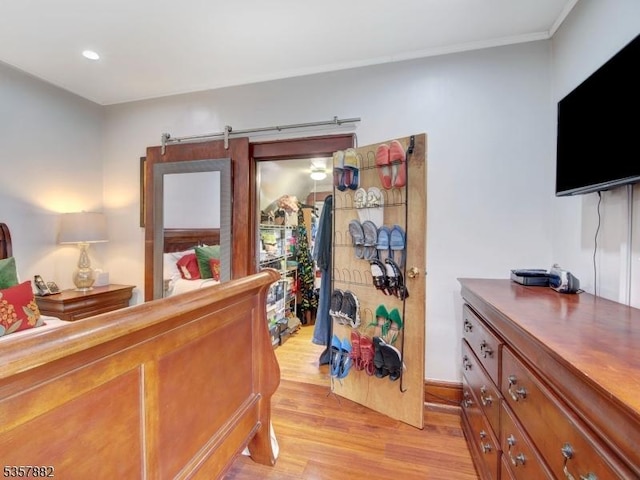 bedroom featuring light wood finished floors, recessed lighting, and ornamental molding