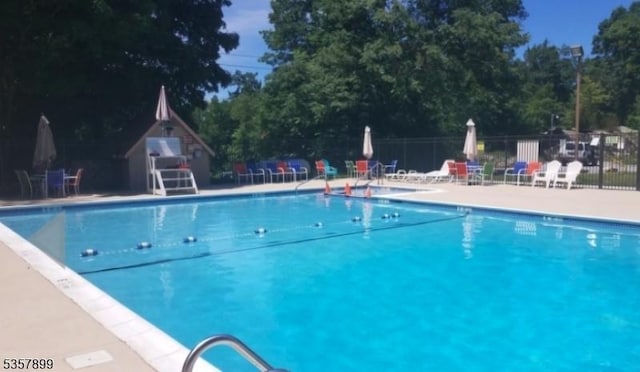 30 Hemlock Vlg, Vernon Twp, NJ 07461 - community pool with a patio area and view of wooded area
