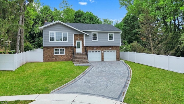 431 W Lookout Ave, Hackensack City, NJ 07601 - raised ranch with brick siding, an attached garage, decorative driveway, and a chimney
