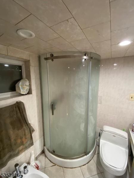 152 Greenwood Ave Unit 2, East Orange City, NJ 07017 - full bath with a bidet, a shower stall, tile walls, tile patterned floors, and toilet