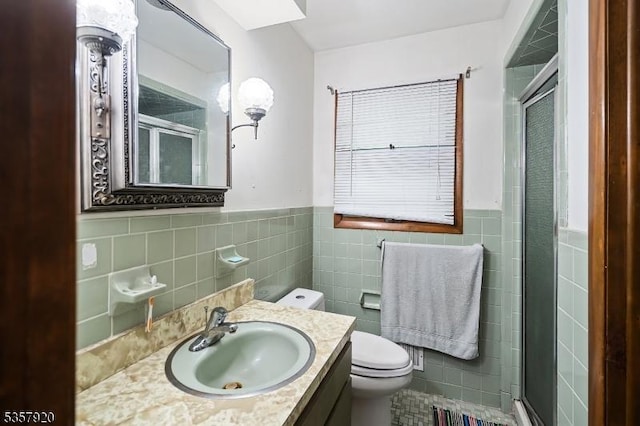 1474 Thomas Ave, North Brunswick Twp, NJ 08902 - full bathroom with tile walls, a stall shower, a wainscoted wall, toilet, and vanity