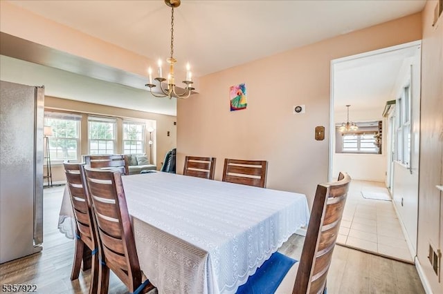 dining space featuring a chandelier and wood finished floors