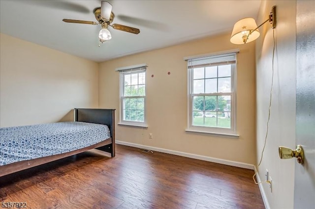 bedroom with wood finished floors, baseboards, and a ceiling fan