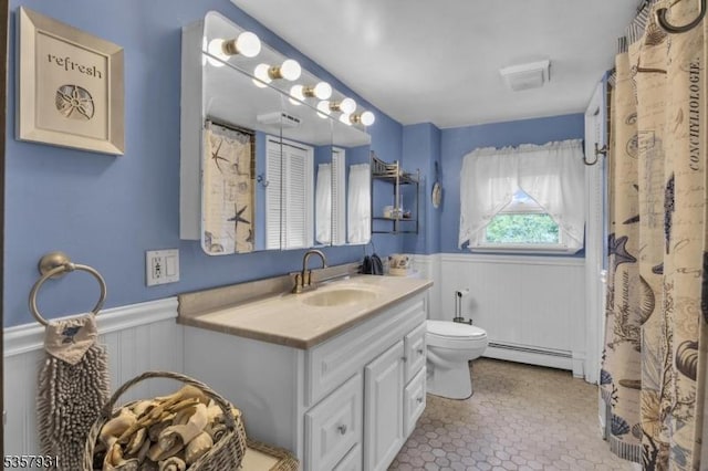 full bathroom featuring a baseboard radiator, wainscoting, toilet, and vanity