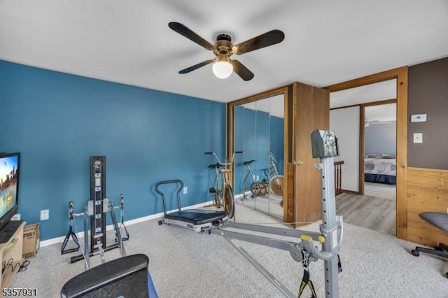 exercise area with ceiling fan, baseboards, and carpet flooring