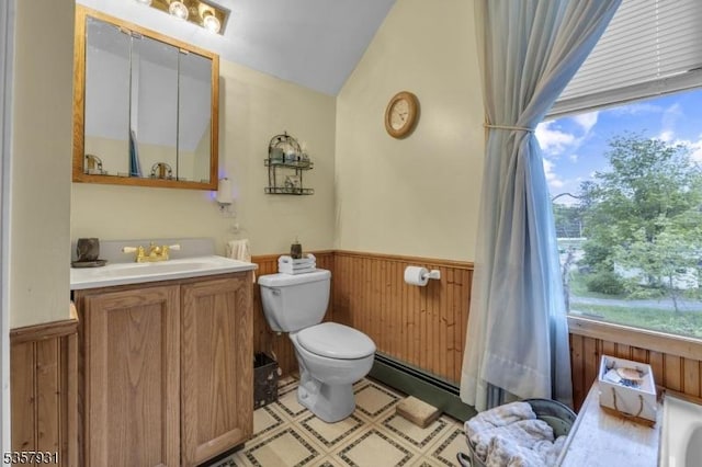 bathroom featuring wainscoting, toilet, plenty of natural light, a baseboard radiator, and wooden walls