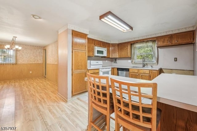 12 Xenia Ct, Mine Hill Twp, NJ 07803 - kitchen with white appliances, a sink, light wood finished floors, a chandelier, and light countertops