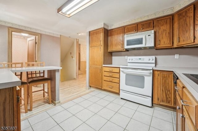 12 Xenia Ct, Mine Hill Twp, NJ 07803 - kitchen featuring white appliances, brown cabinets, and light countertops