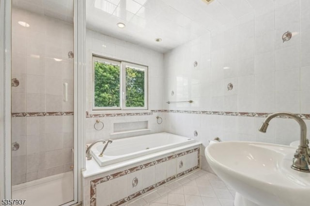12 Xenia Ct, Mine Hill Twp, NJ 07803 - bathroom with tile walls, a stall shower, tile patterned flooring, a garden tub, and a sink