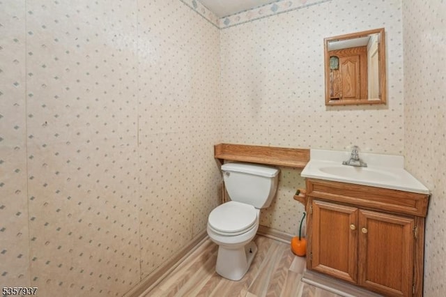12 Xenia Ct, Mine Hill Twp, NJ 07803 - bathroom featuring wood finished floors, wallpapered walls, toilet, and vanity