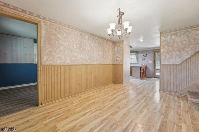 12 Xenia Ct, Mine Hill Twp, NJ 07803 - empty room featuring a wainscoted wall, a chandelier, and wood finished floors