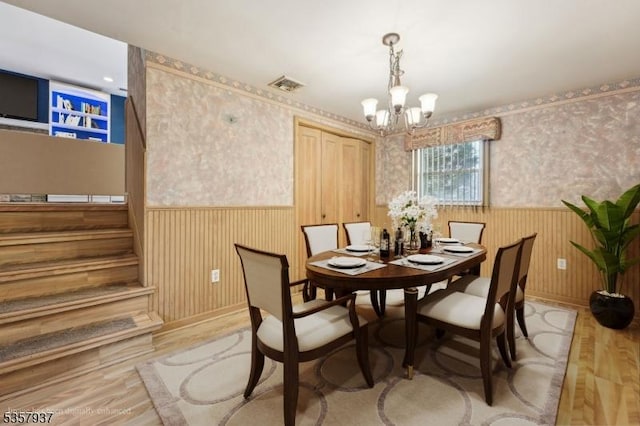 12 Xenia Ct, Mine Hill Twp, NJ 07803 - dining space with wainscoting, a chandelier, wallpapered walls, and light wood-style floors