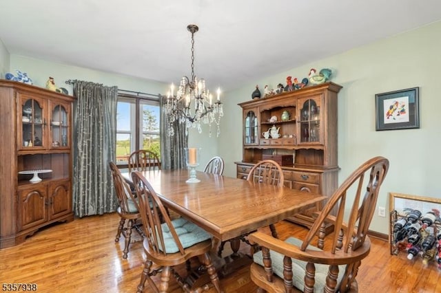 dining space featuring a chandelier and light wood finished floors