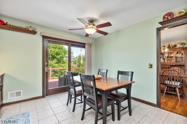 dining area with ceiling fan, light tile patterned floors, and baseboards