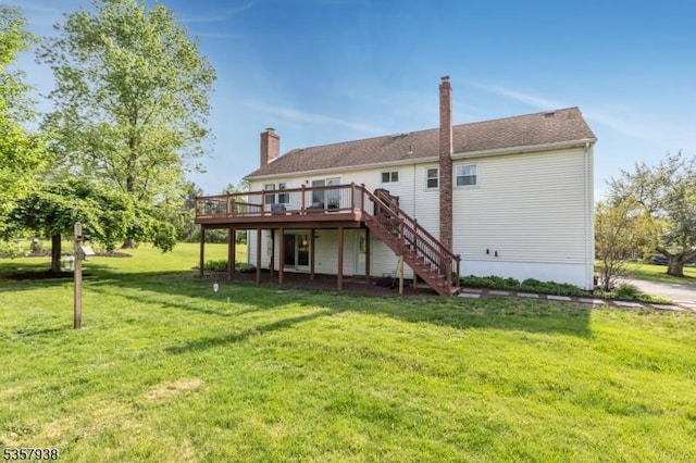 back of property featuring a deck, stairs, a yard, and a chimney