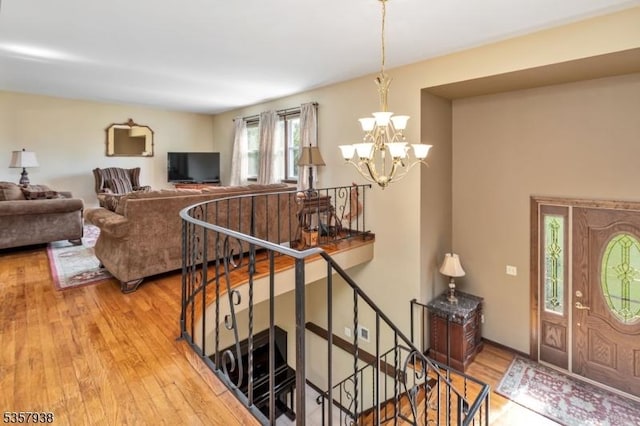living area featuring a chandelier and light wood finished floors