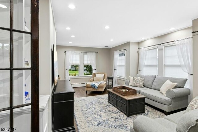 living room with a baseboard radiator, recessed lighting, and wood finished floors