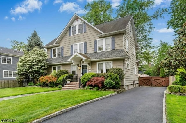 view of front of home with a gate and a shingled roof