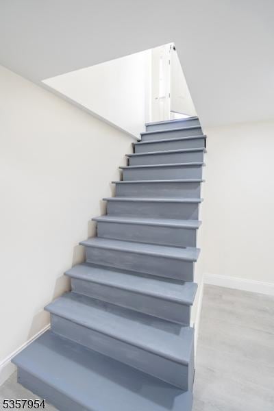 56 Laventhal Ave, Irvington Twp, NJ 07111 - stairs featuring baseboards and wood finished floors