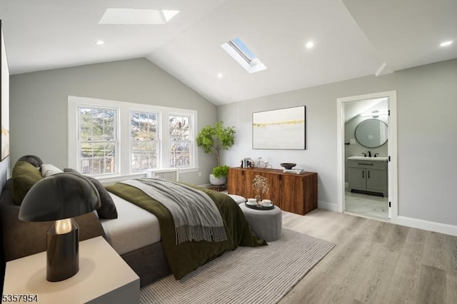 56 Laventhal Ave, Irvington Twp, NJ 07111 - bedroom featuring a skylight, a sink, light wood-style flooring, vaulted ceiling, and baseboards