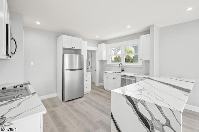 56 Laventhal Ave, Irvington Twp, NJ 07111 - kitchen featuring stainless steel appliances, light stone counters, a sink, a peninsula, and white cabinets