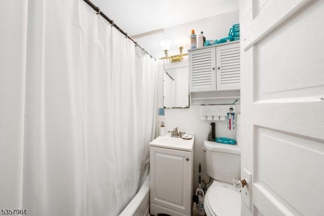 bathroom featuring toilet, a sink, and shower / bath combo