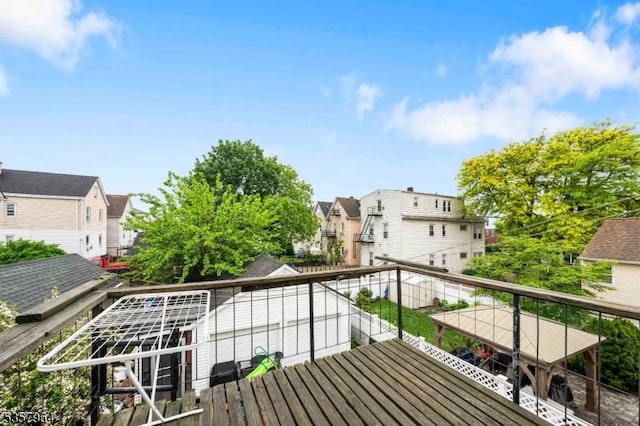 wooden terrace featuring a residential view