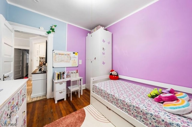 bedroom with dark wood-type flooring and crown molding