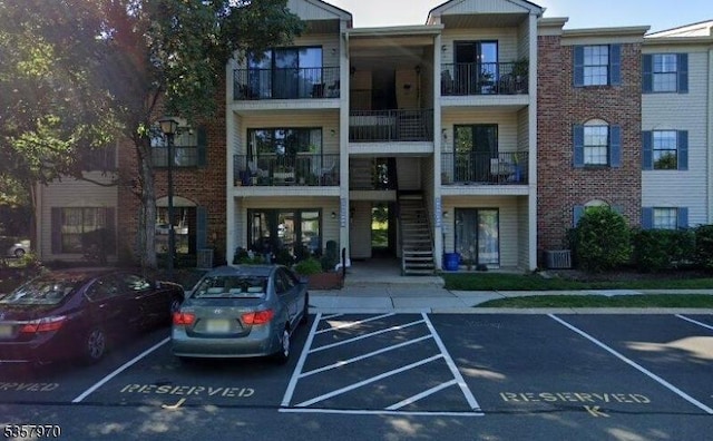 26 Fisher Dr Unit 2704, Franklin Twp, NJ 08823 - view of building exterior featuring uncovered parking