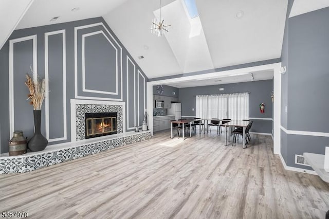 26 Fisher Dr Unit 2704, Franklin Twp, NJ 08823 - living room featuring wood finished floors, high vaulted ceiling, a fireplace, and baseboards