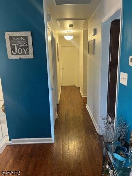 800 Raritan Rd, Clark Twp, NJ 07066 - hallway featuring attic access, dark wood-style flooring, and baseboards