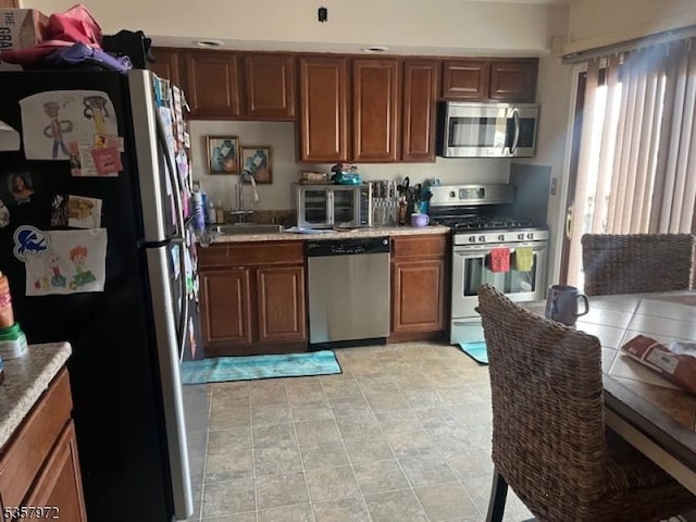 800 Raritan Rd, Clark Twp, NJ 07066 - kitchen featuring stainless steel appliances, a sink, light countertops, and brown cabinets