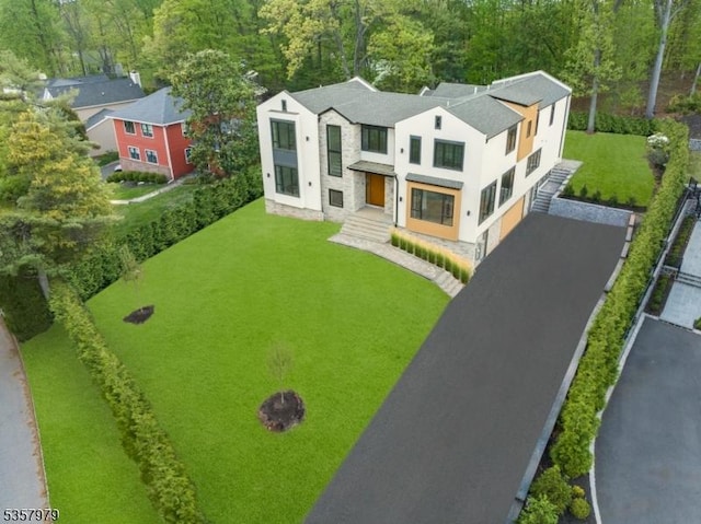 370 Hartshorn Dr, Millburn Twp, NJ 07078 - view of front of house with stucco siding, stone siding, driveway, and a front lawn