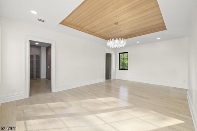 370 Hartshorn Dr, Millburn Twp, NJ 07078 - empty room with a tray ceiling, wooden ceiling, a chandelier, wood finished floors, and baseboards