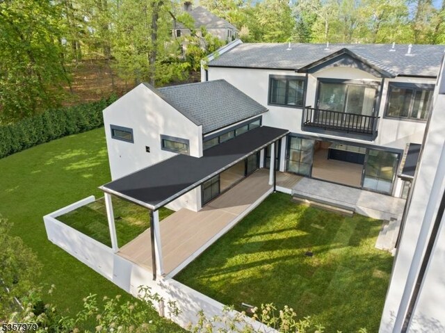 370 Hartshorn Dr, Millburn Twp, NJ 07078 - rear view of property with a balcony, stucco siding, and a lawn