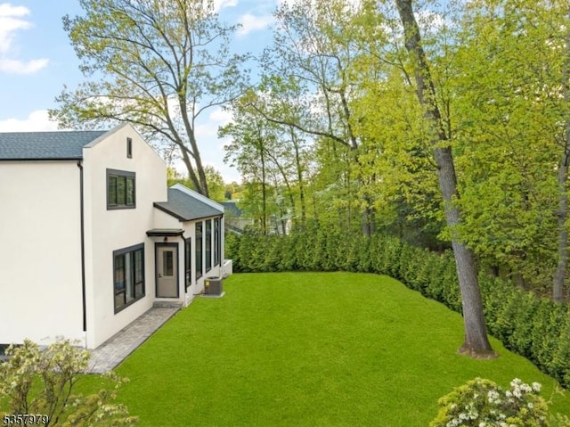 370 Hartshorn Dr, Millburn Twp, NJ 07078 - view of grassy yard with central AC and a sunroom