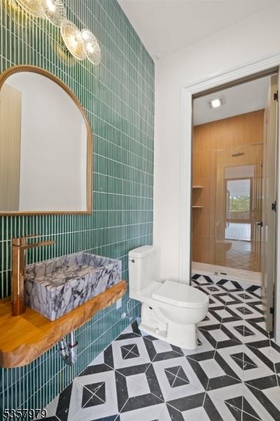 370 Hartshorn Dr, Millburn Twp, NJ 07078 - bathroom with tile walls, toilet, and tile patterned flooring