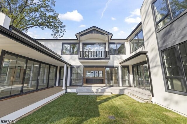 370 Hartshorn Dr, Millburn Twp, NJ 07078 - rear view of property with a balcony, stucco siding, a lawn, and a patio area